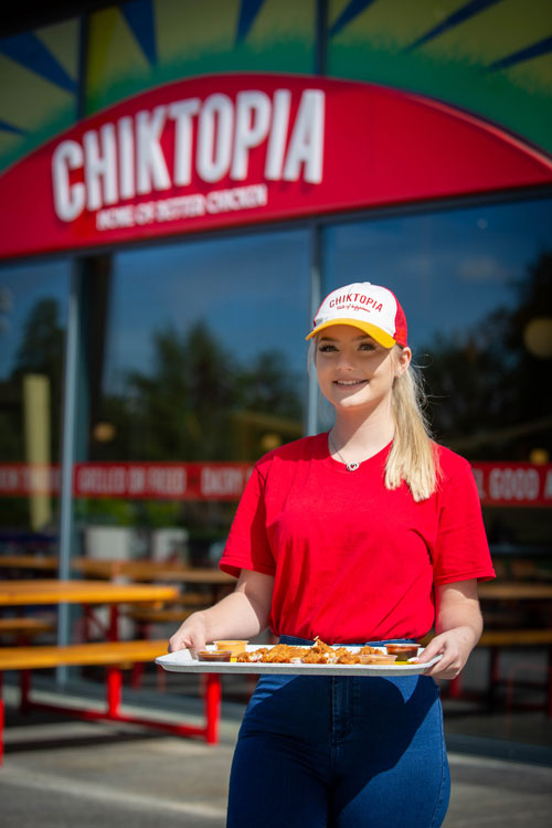 Lady serving food in Chicktopia